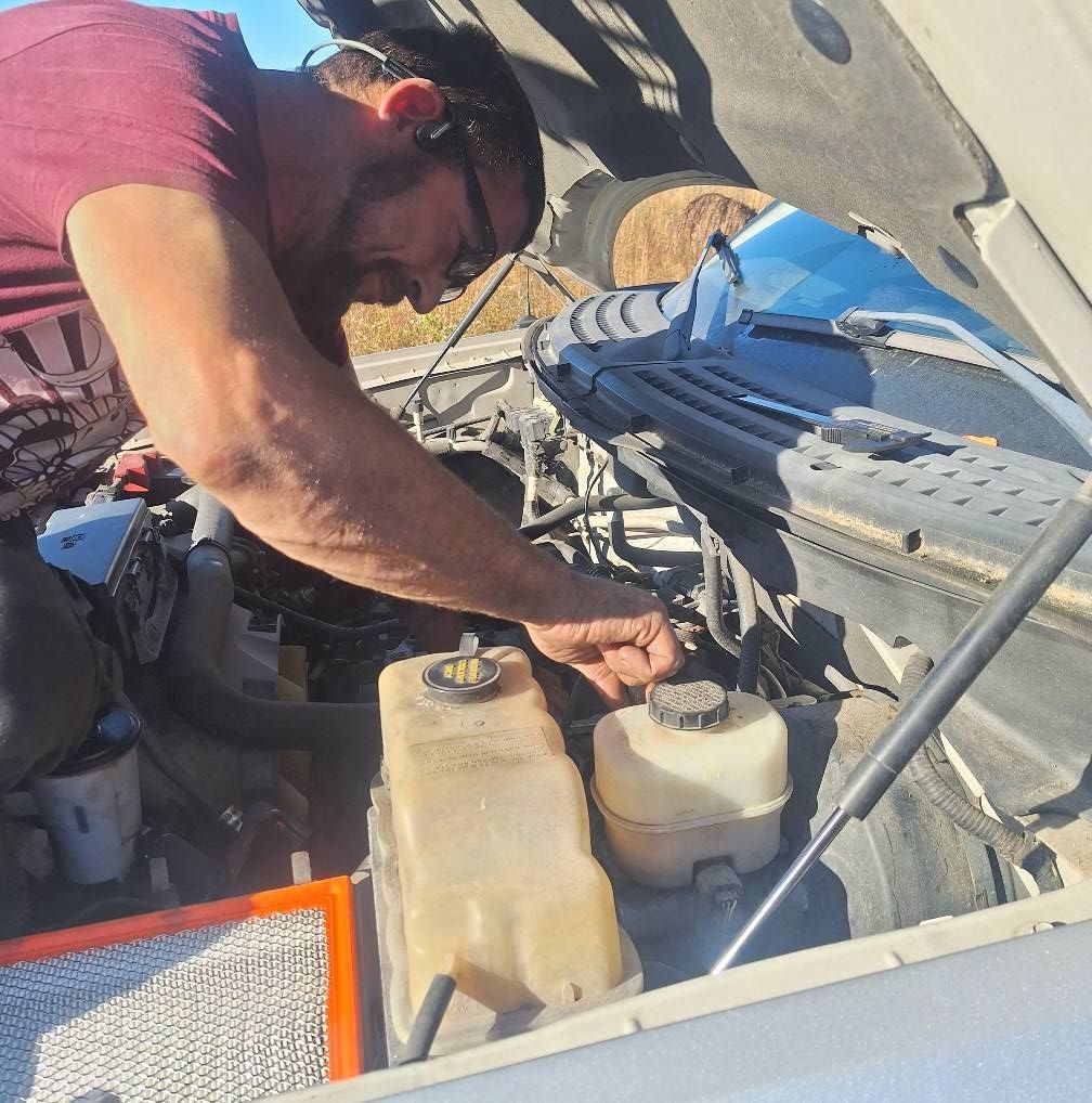 A man wearing a hard hat and goggles is standing in a room.