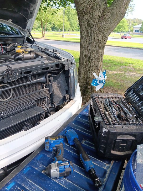 A man wearing a hard hat and goggles is standing in a room.