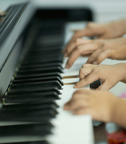 Mother and little boy playing piano.