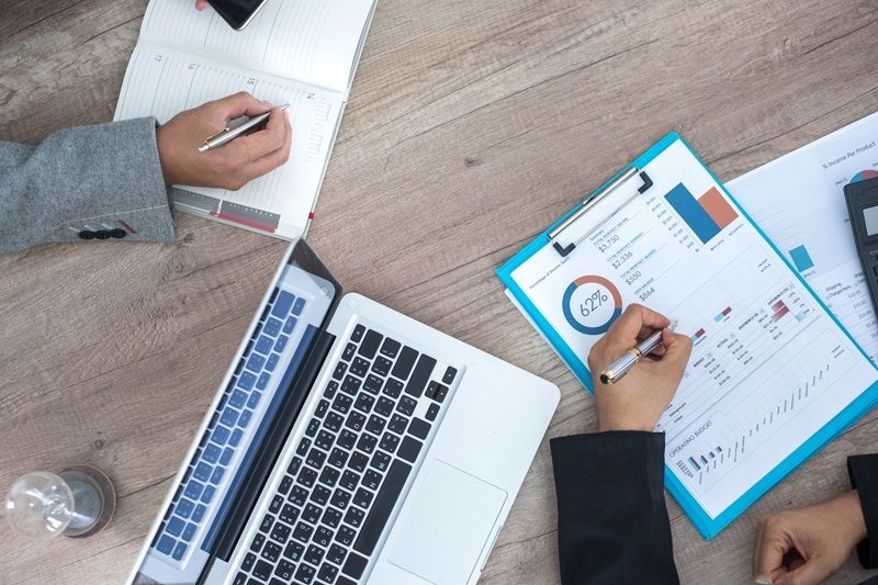 Aerial view: Waterfront Key West scene with buildings, people, trolley, and ocean.