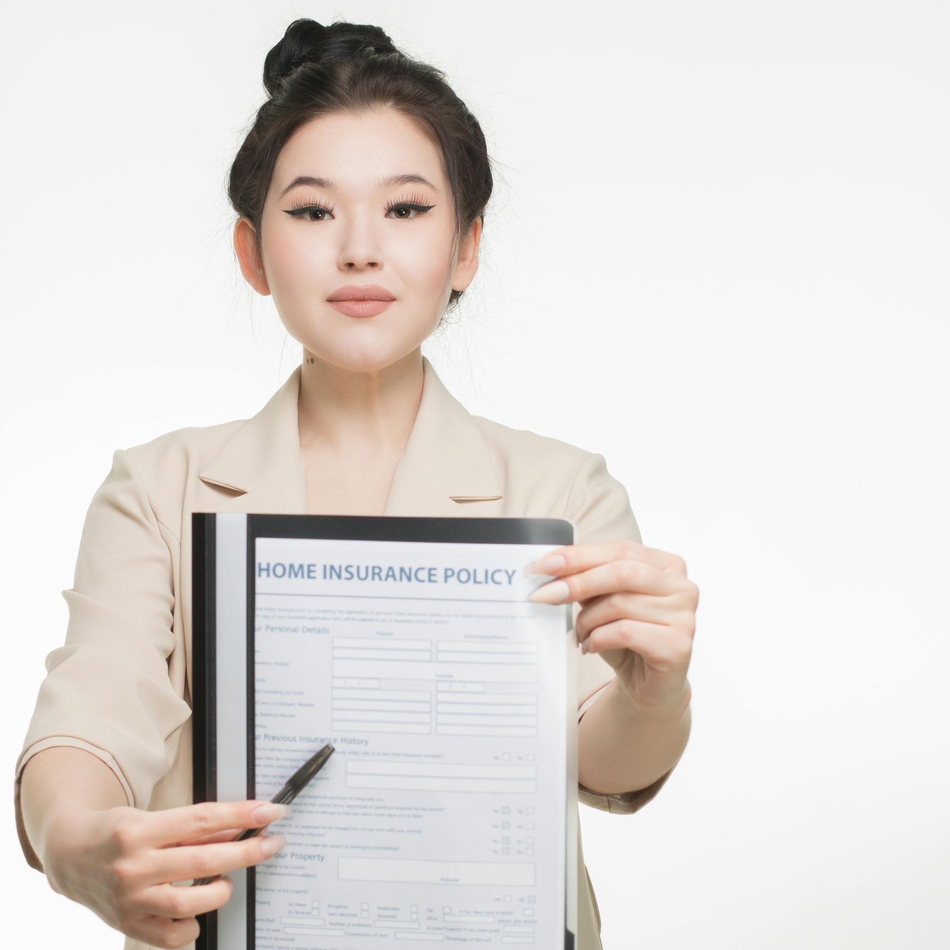 Woman in beige suit holds and points to a