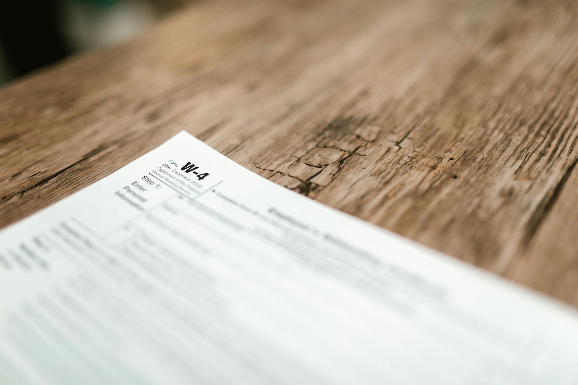 White document with tax form information on a wood grain surface.