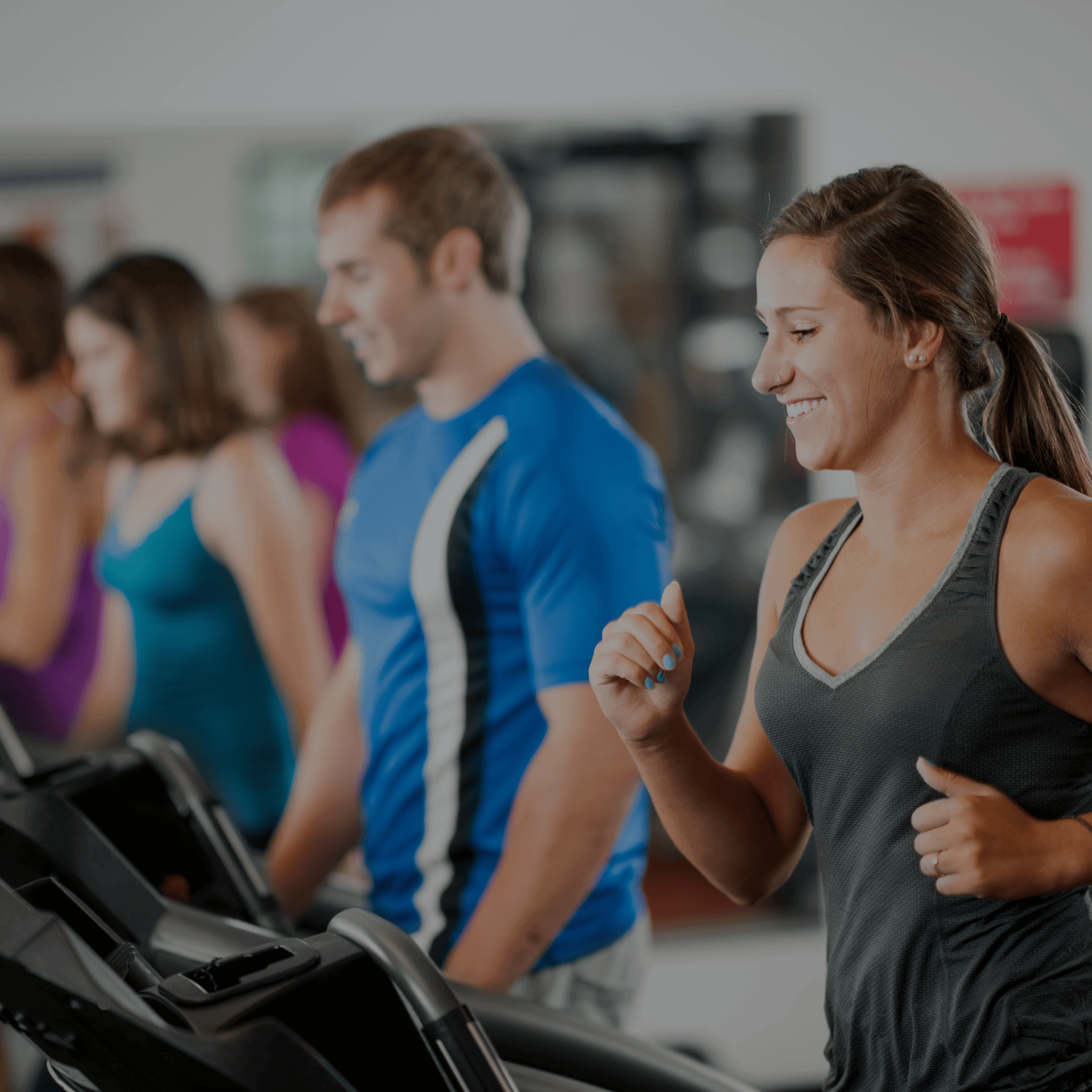 People exercising in a modern gym, symbolizing Gym Revival Group's impact on client transformation.