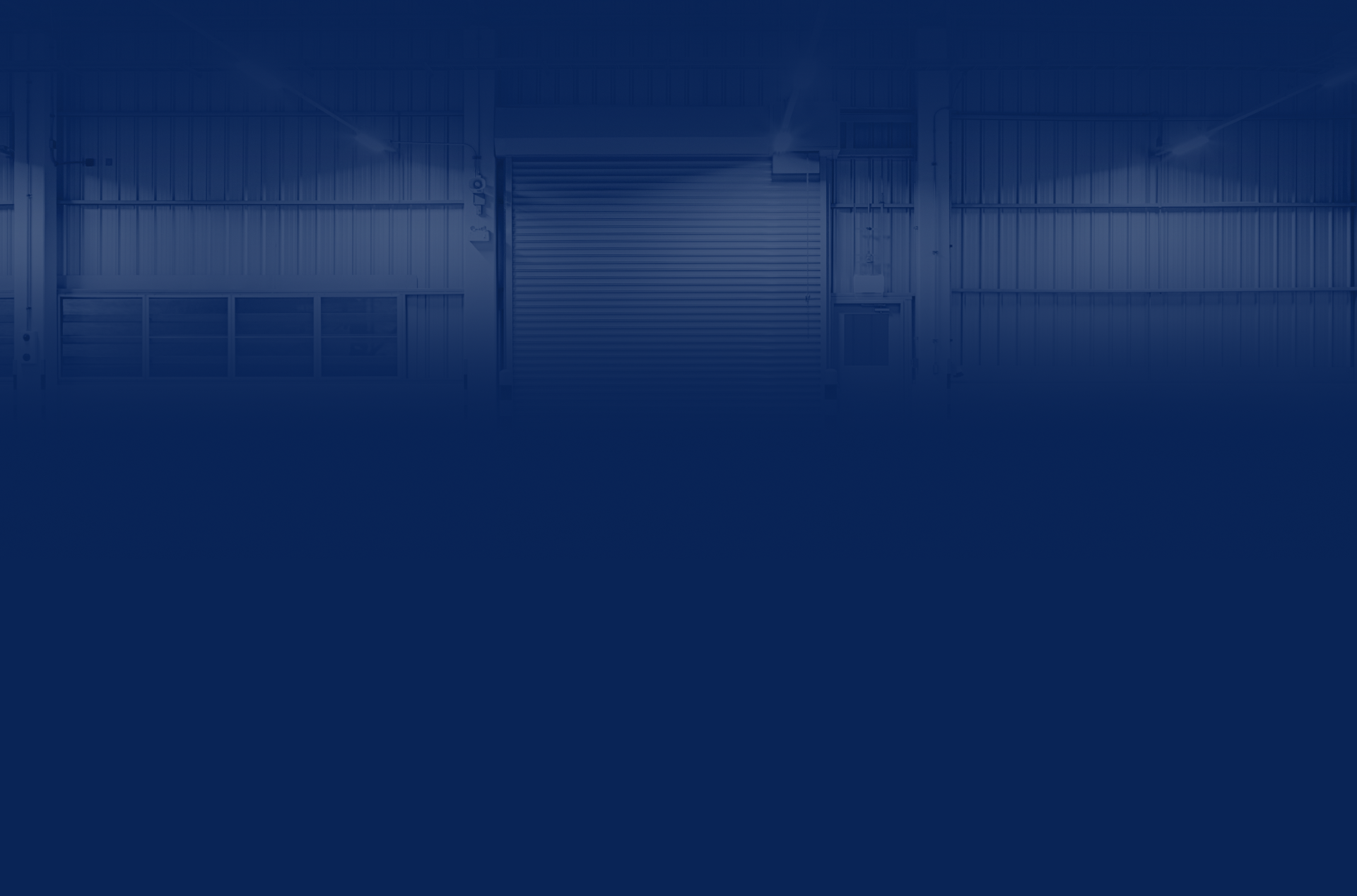 Dark blue-toned warehouse interior; roller door in center, corrugated metal walls | Chip Ragans Auto, LLC