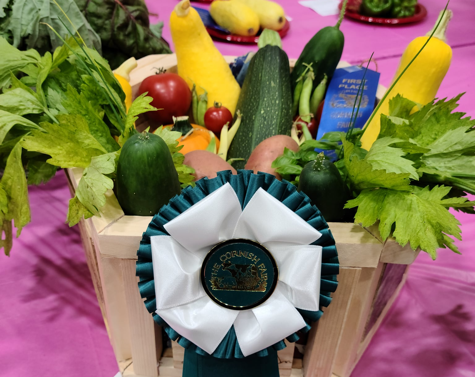 A basket of vegetables with a ribbon on top