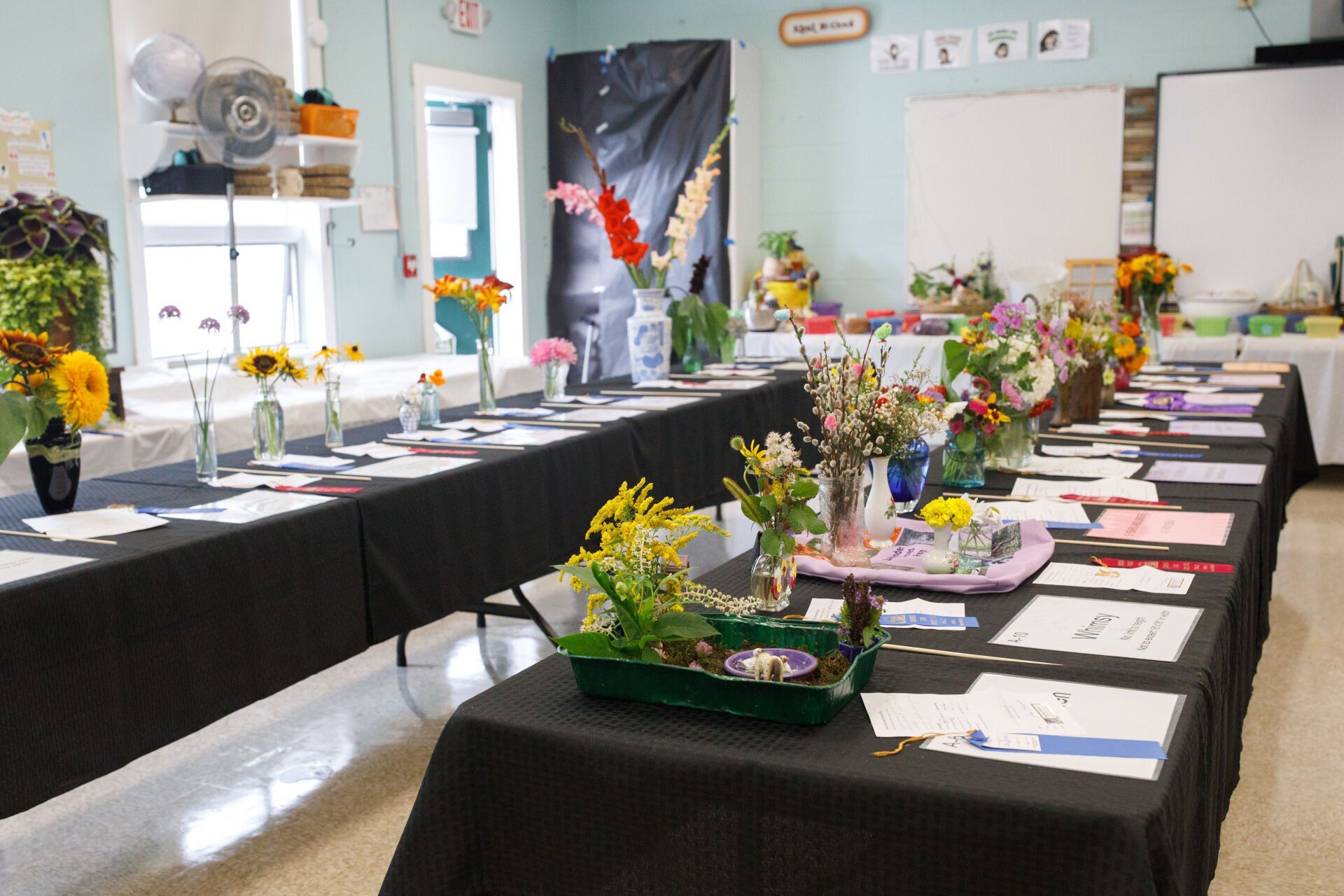 A room filled with tables and vases of flowers