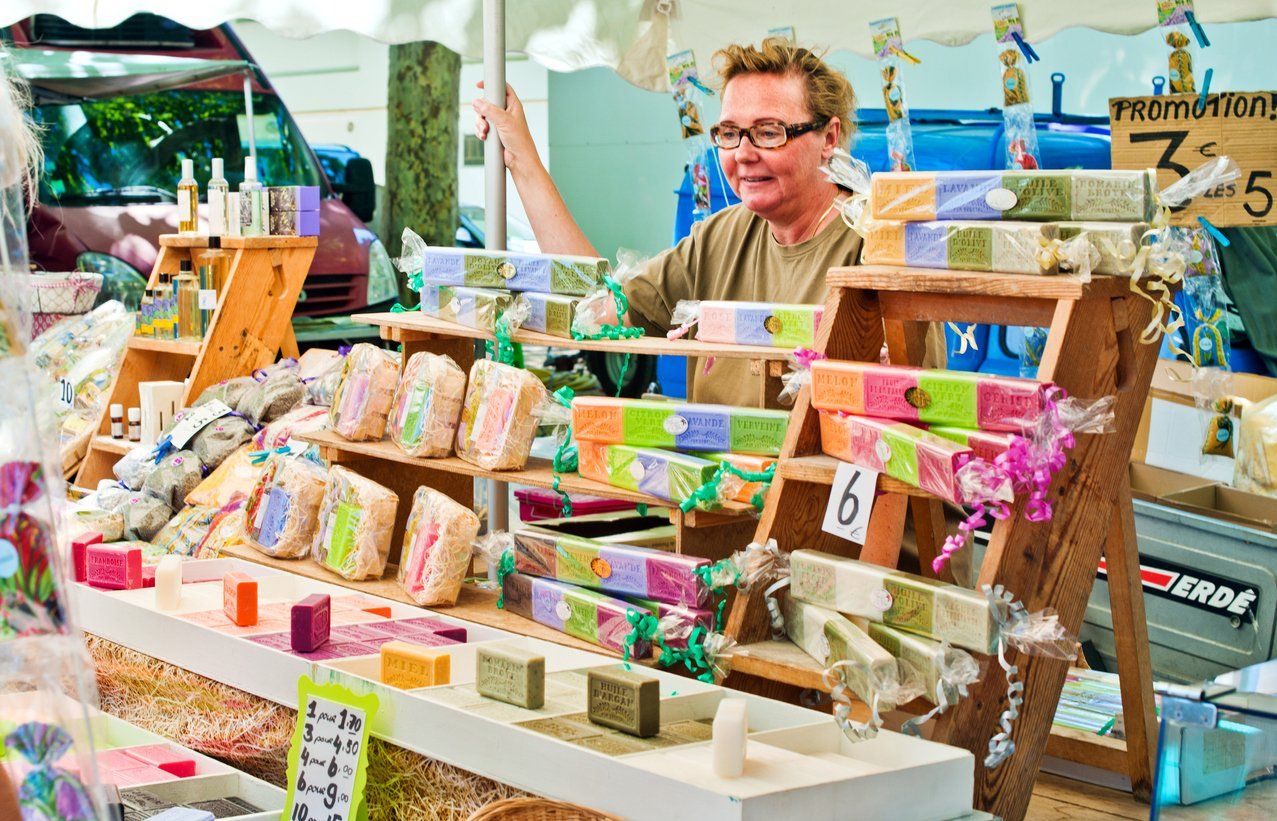 A man is selling soap at a market.