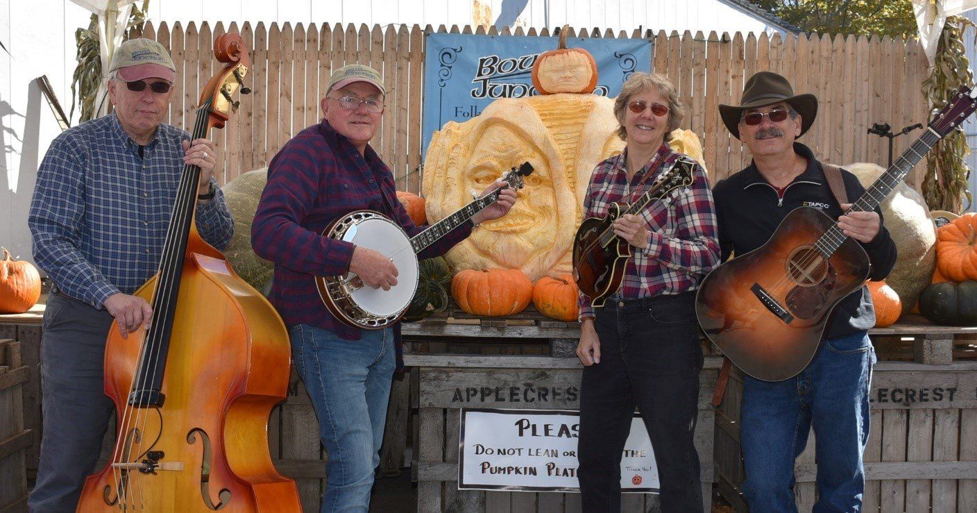 A group of men standing next to each other holding musical instruments.