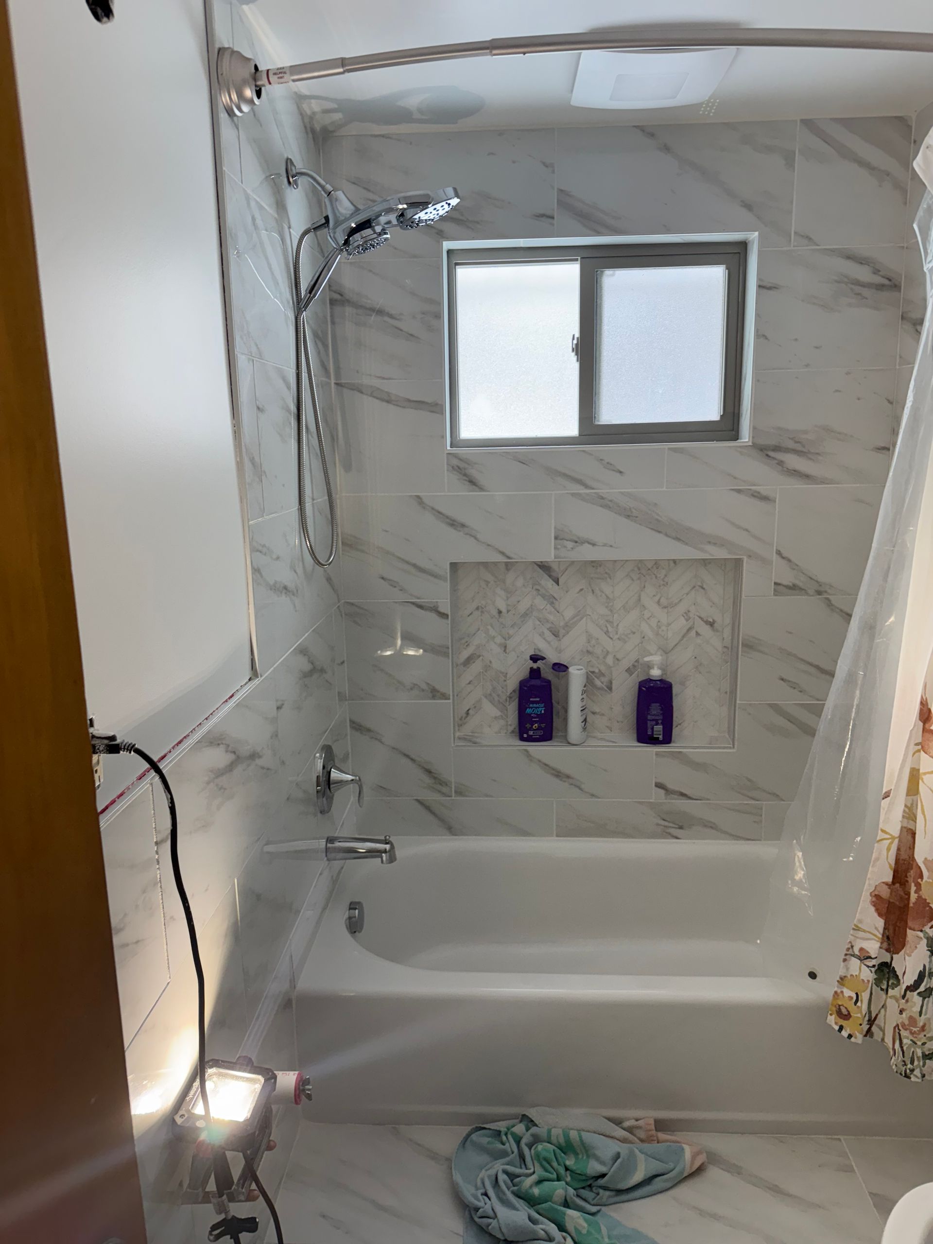 A room with a lot of pipes and a boiler on the wall.