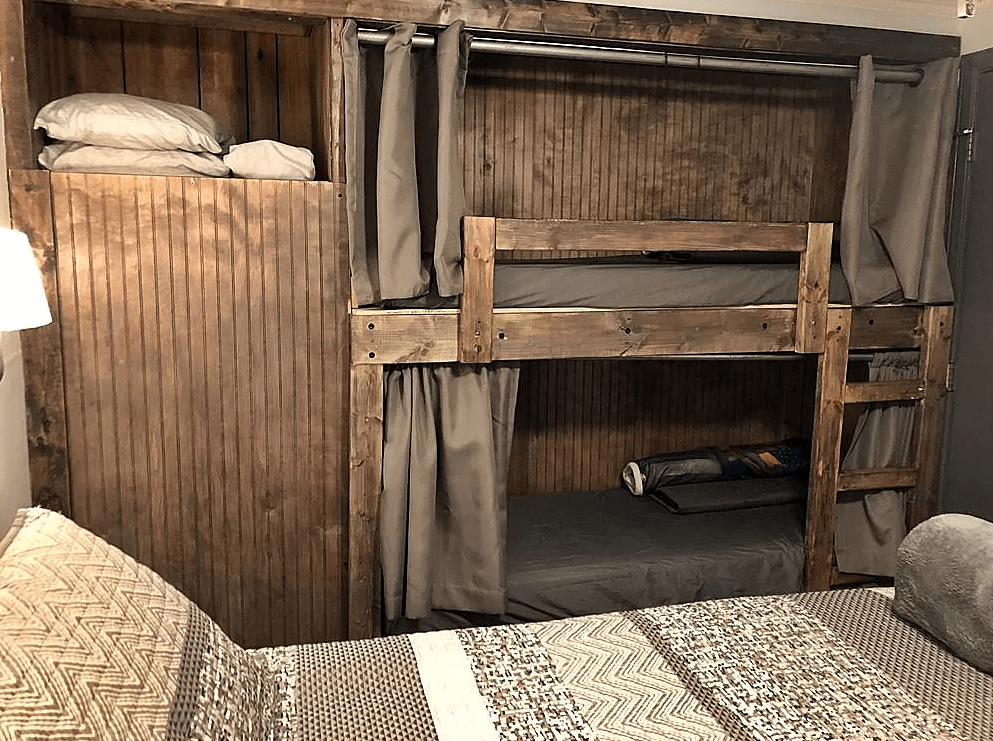 A bedroom with a bunk bed and a bed.