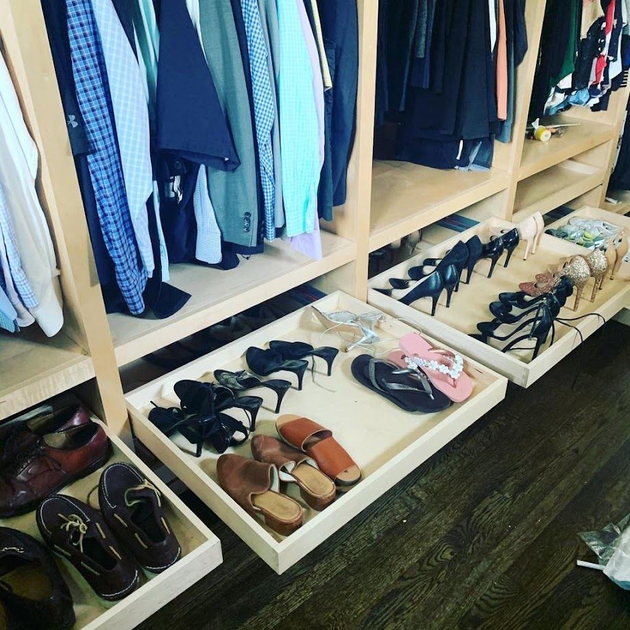 A closet filled with lots of shoes and clothes