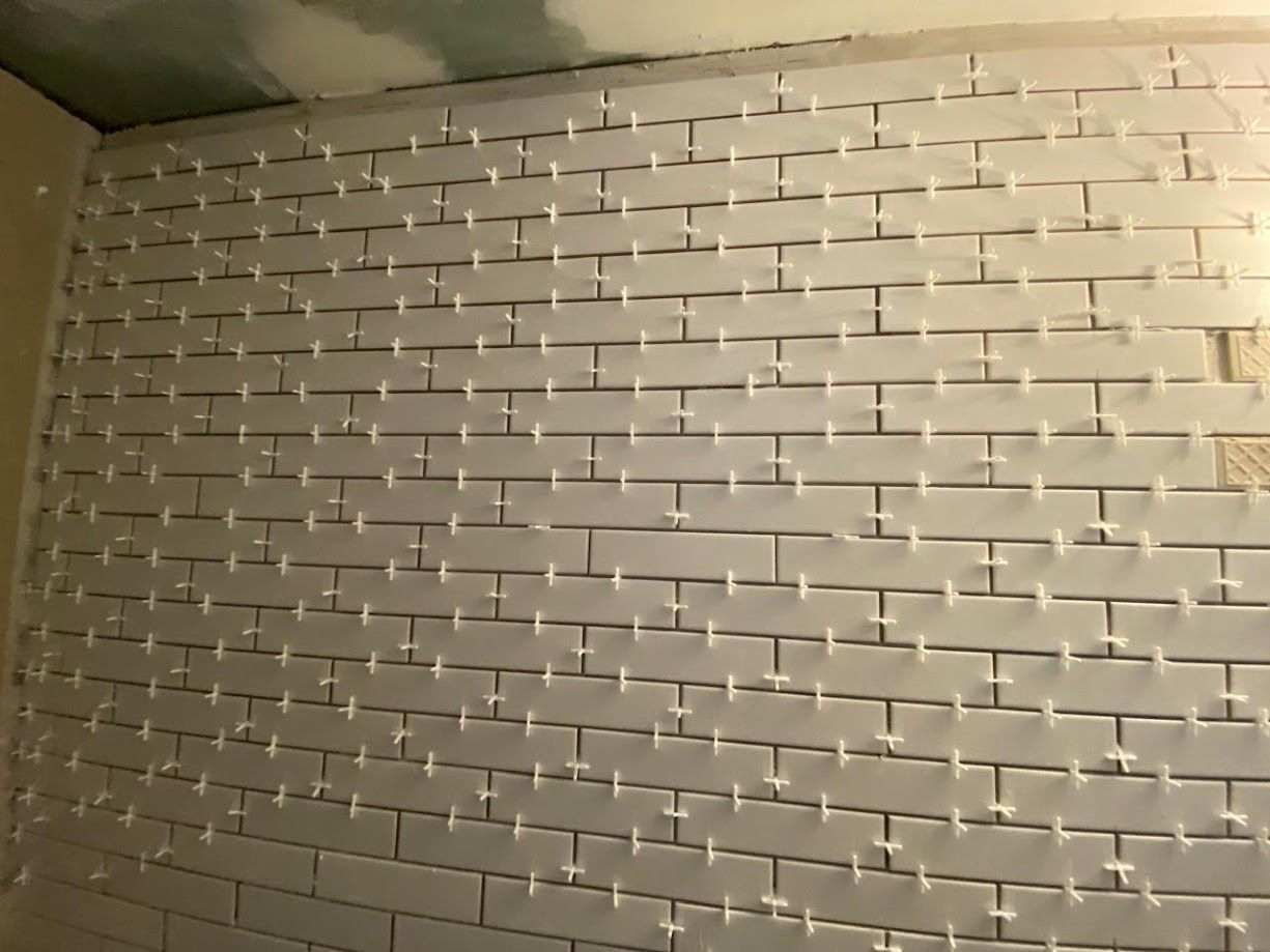A wall with a lot of white tiles on it
