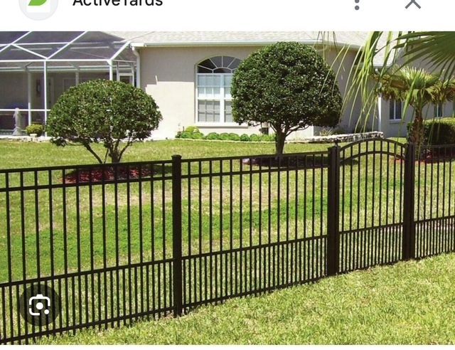 A picture of a fence in front of a house