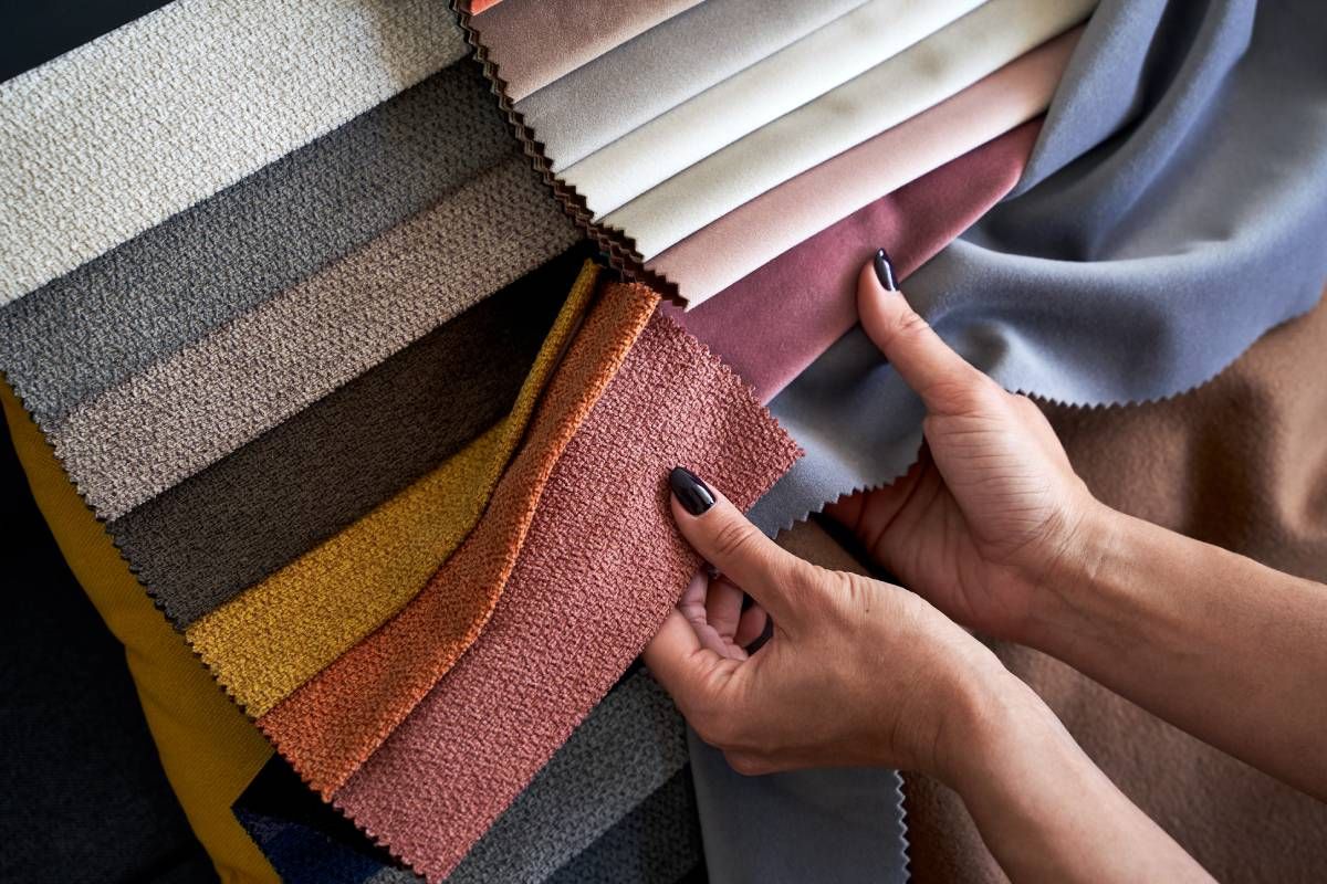 Choosing upholstery fabric color and texture from various colorful samples near Warrenton, VA