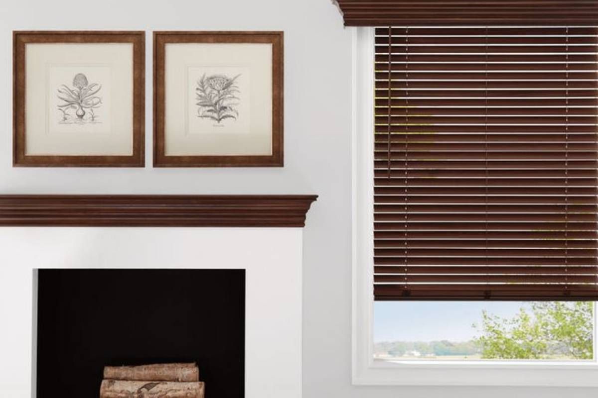 Hunter Douglas Parkland® Wood Blinds in a Living Room Window Next to a Fireplace at Style Savvy Designs near Warrenton, VA