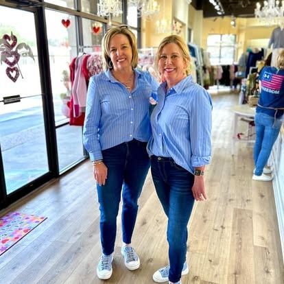 Two women are standing next to each other in a store.