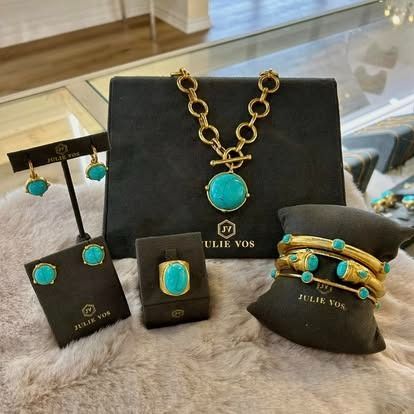 A necklace , earrings , bracelets , and ring are on display in a store.