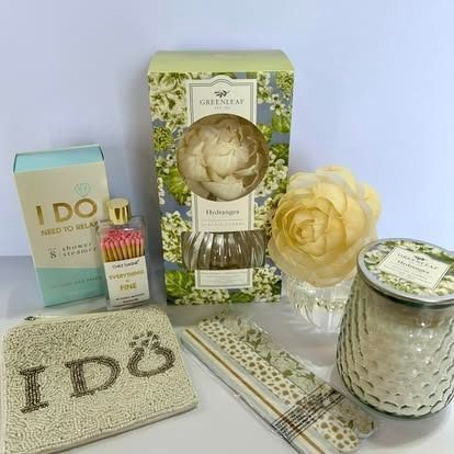 A table topped with a variety of candles , matches , and flowers.