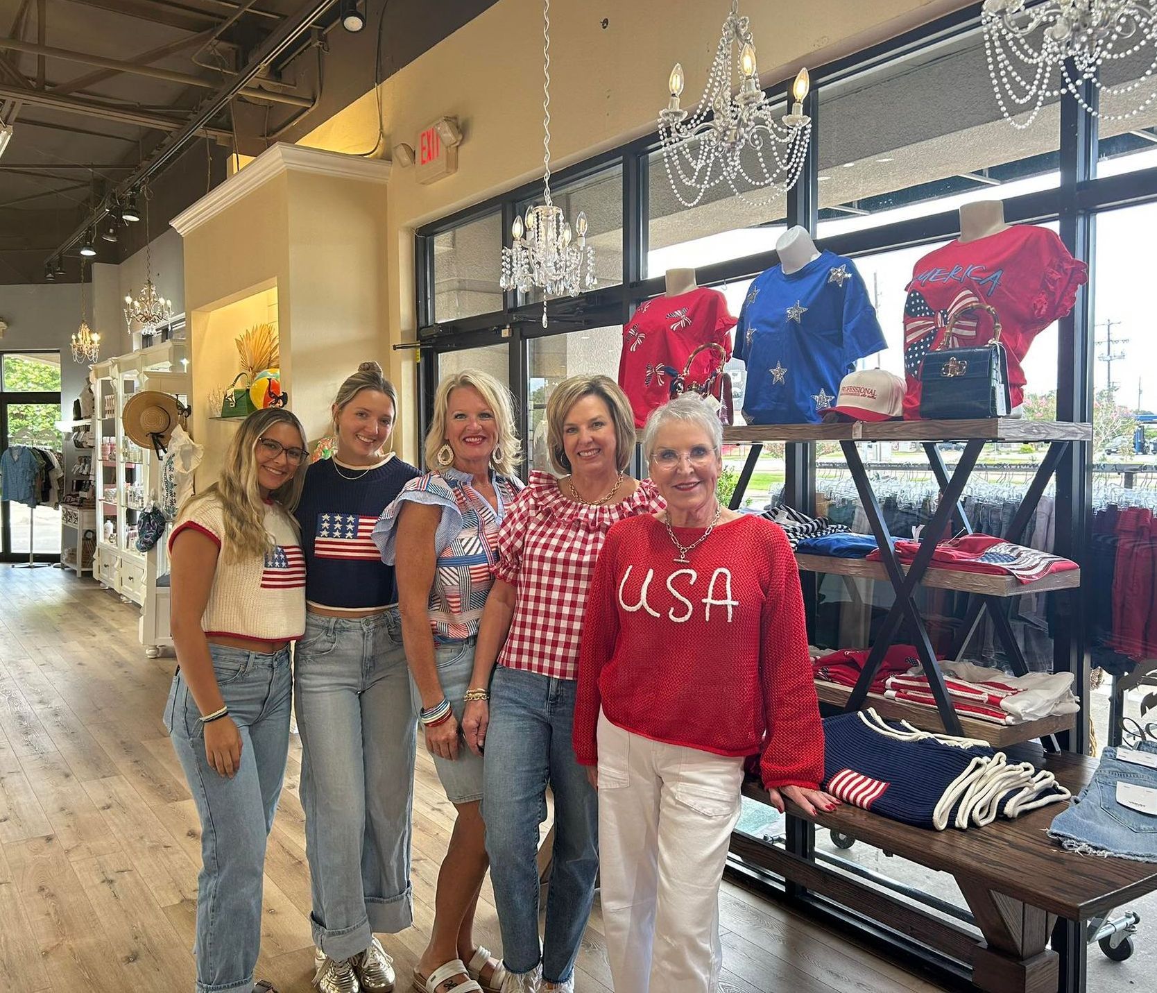 Three women are standing next to each other in a store wearing pajamas.
