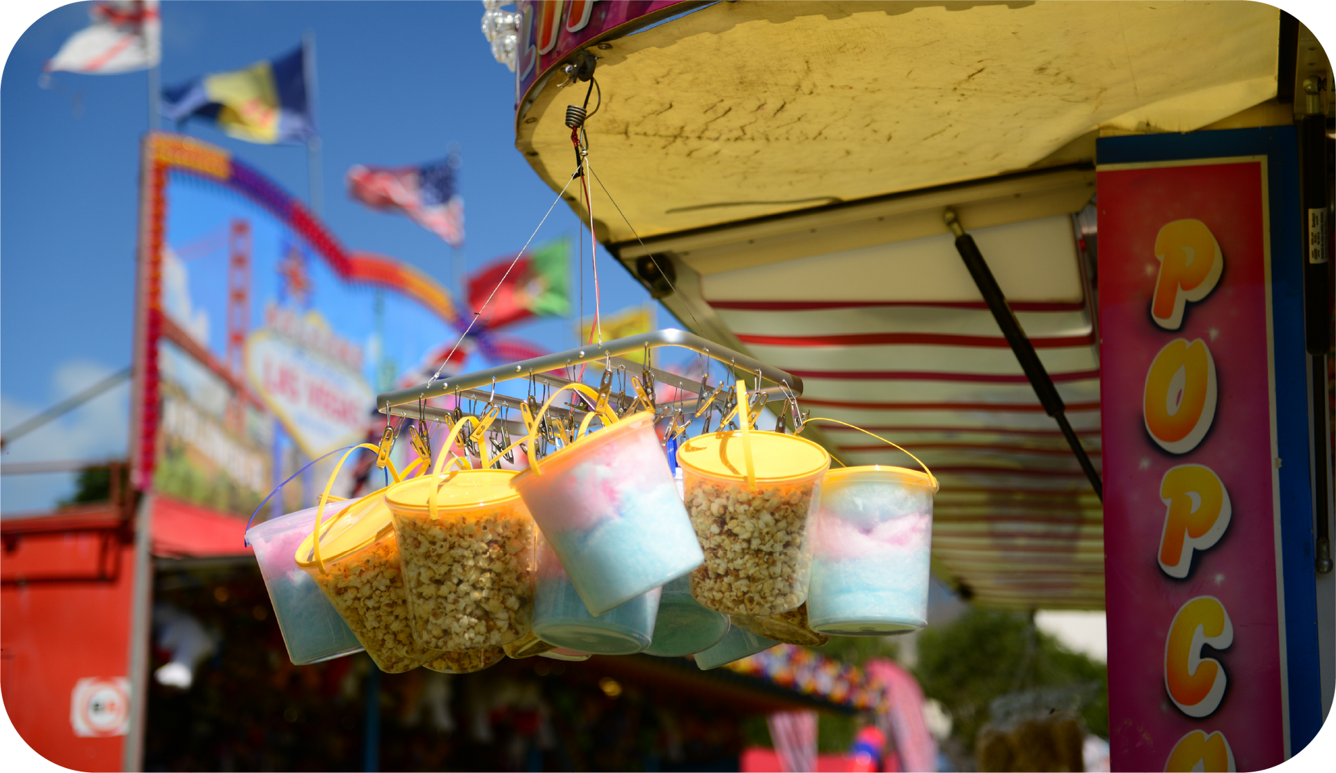 A carnival booth selling cotton candy and popcorn