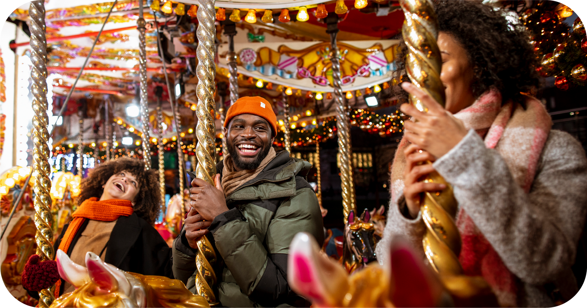 A group of people are riding a merry go round at a carnival.