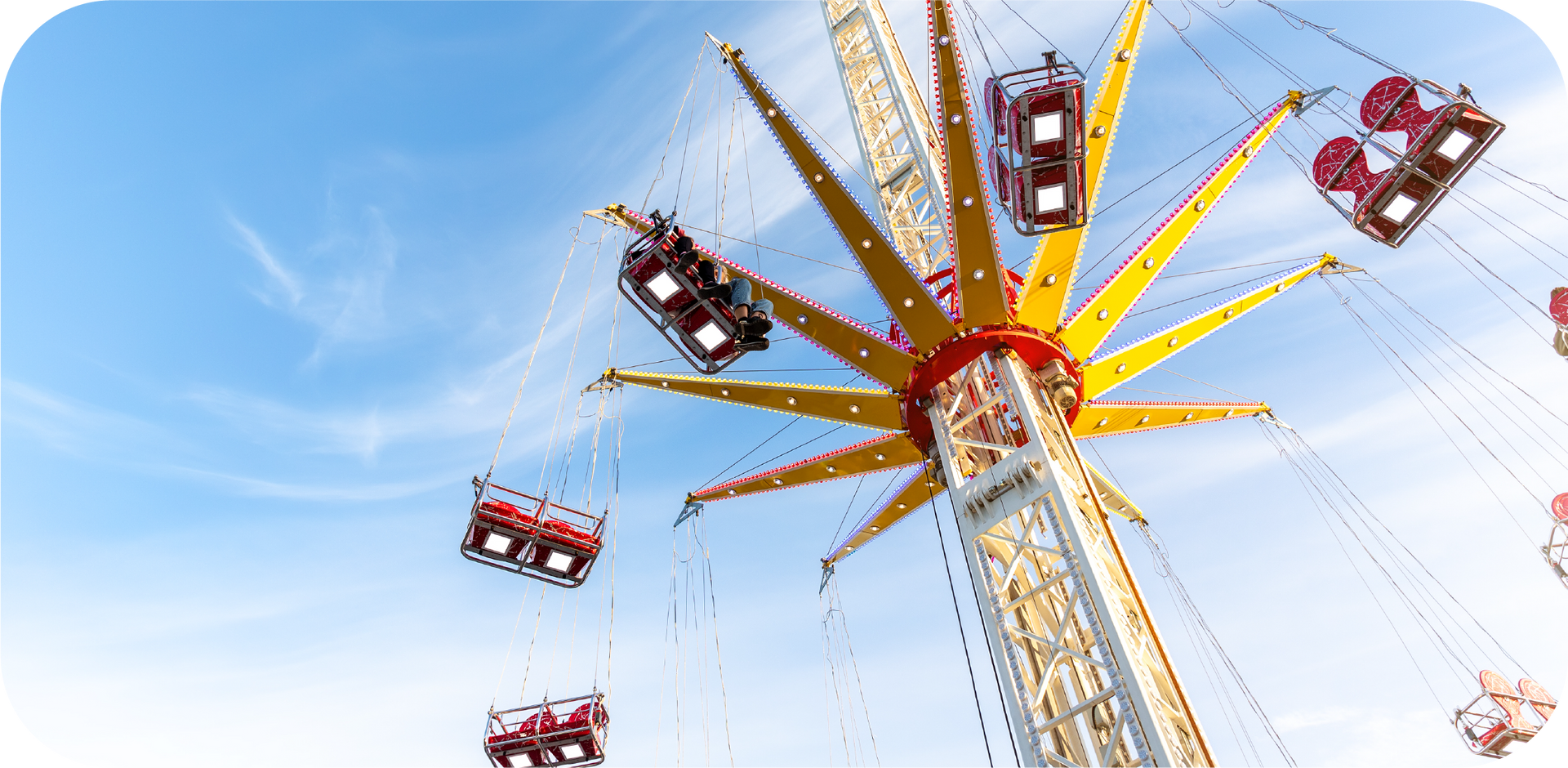 A ferris wheel at an amusement park with people riding it.