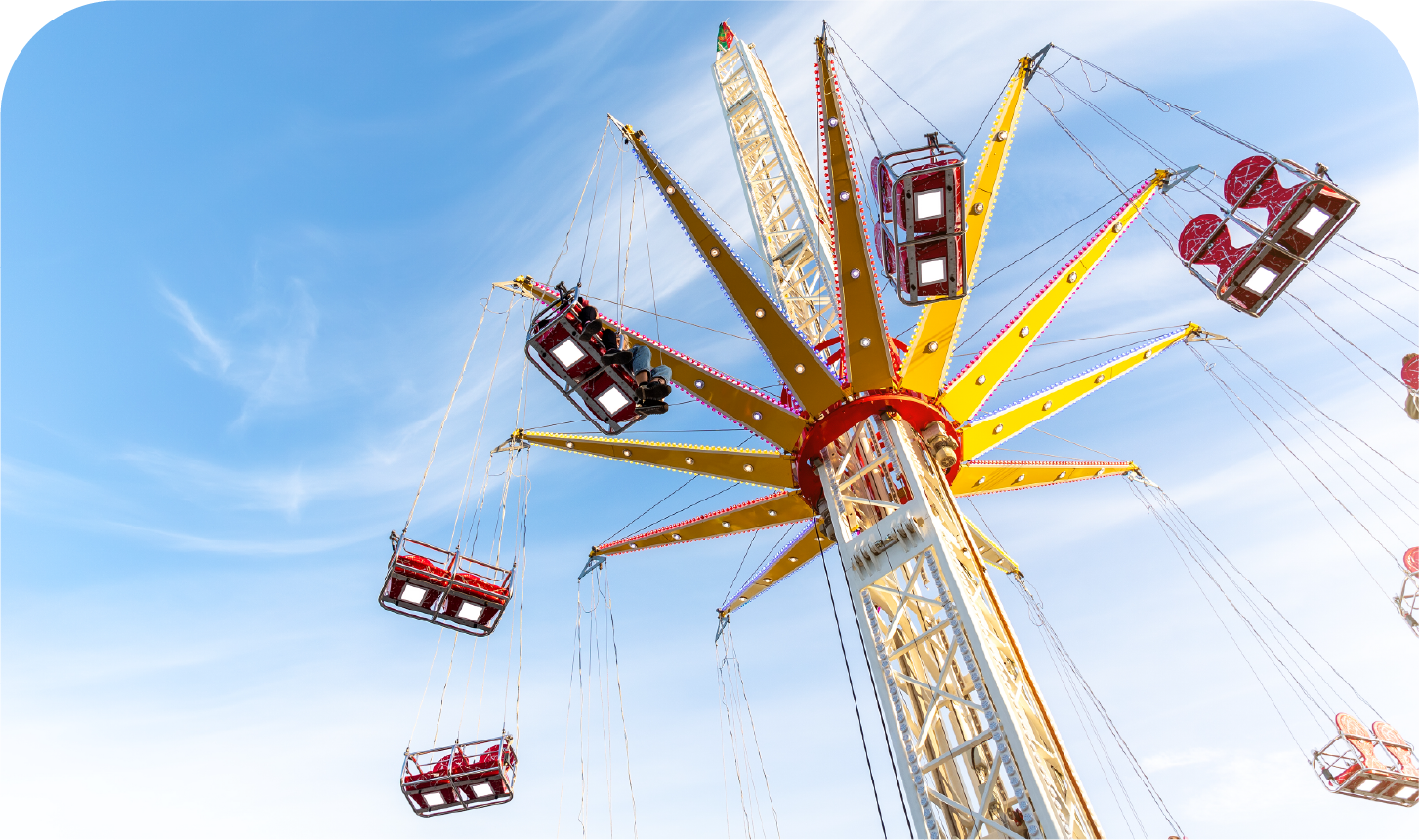 A group of people are riding a ferris wheel at an amusement park.