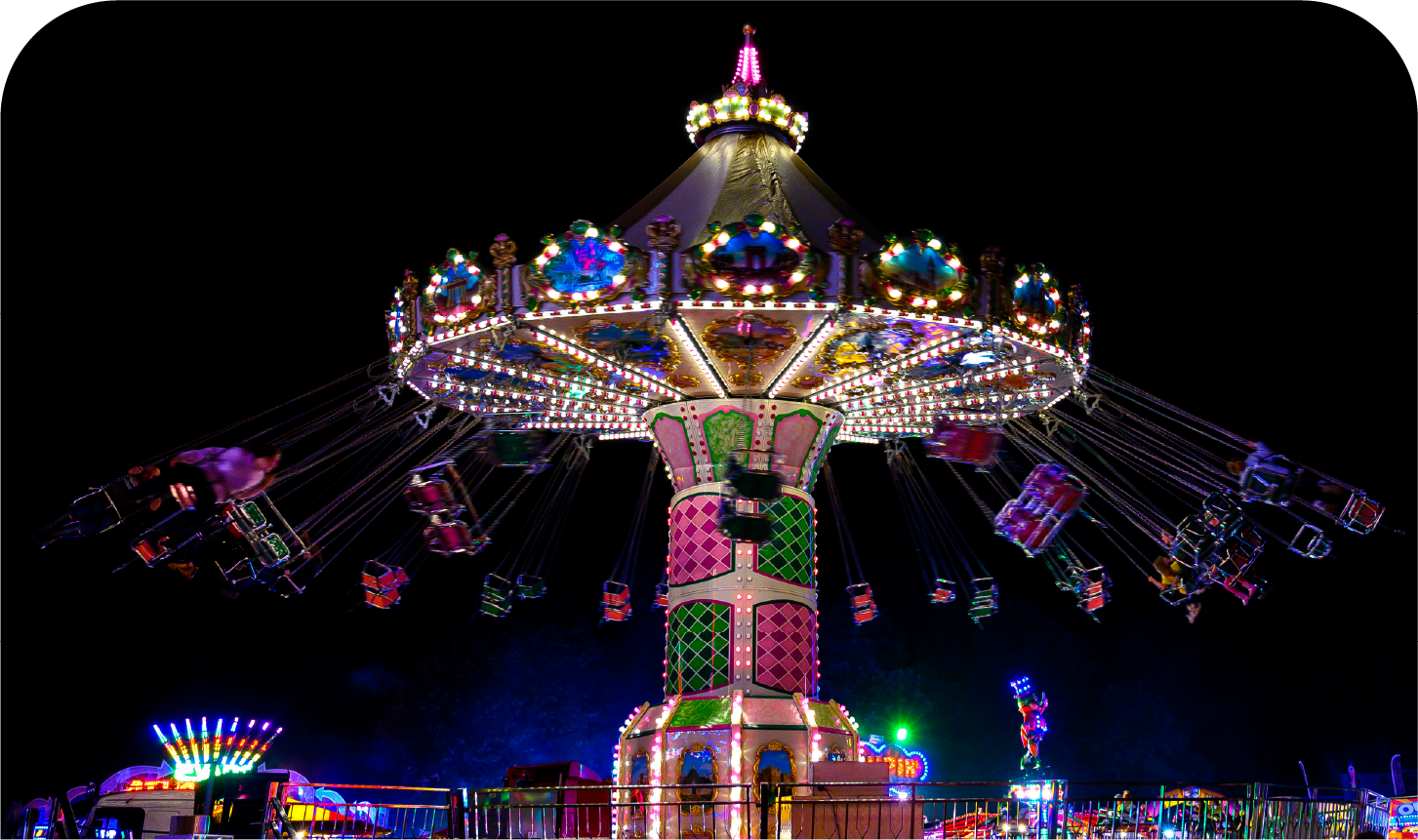 A merry go round at an amusement park at night.