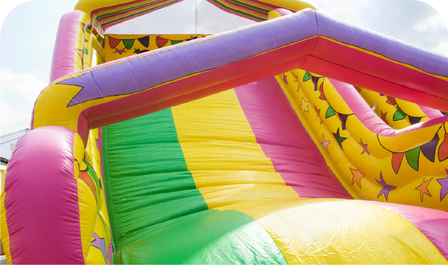 A colorful inflatable slide with a rainbow of colors on it.