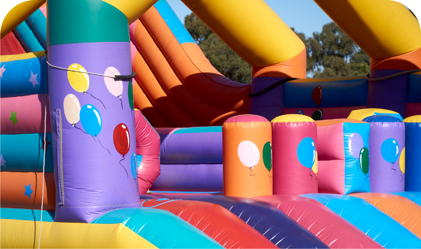 A colorful bouncy house with balloons on it