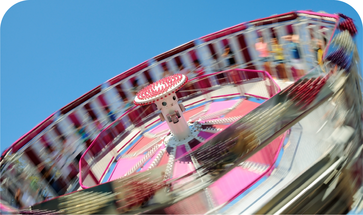 A ferris wheel at a carnival with people riding it