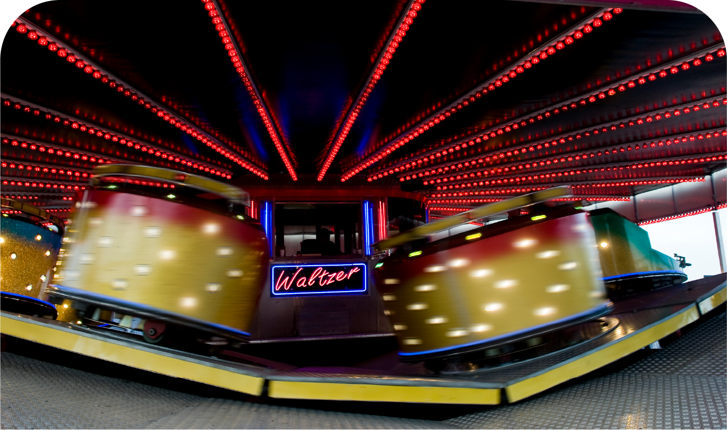 A carnival ride with a neon sign that says walter