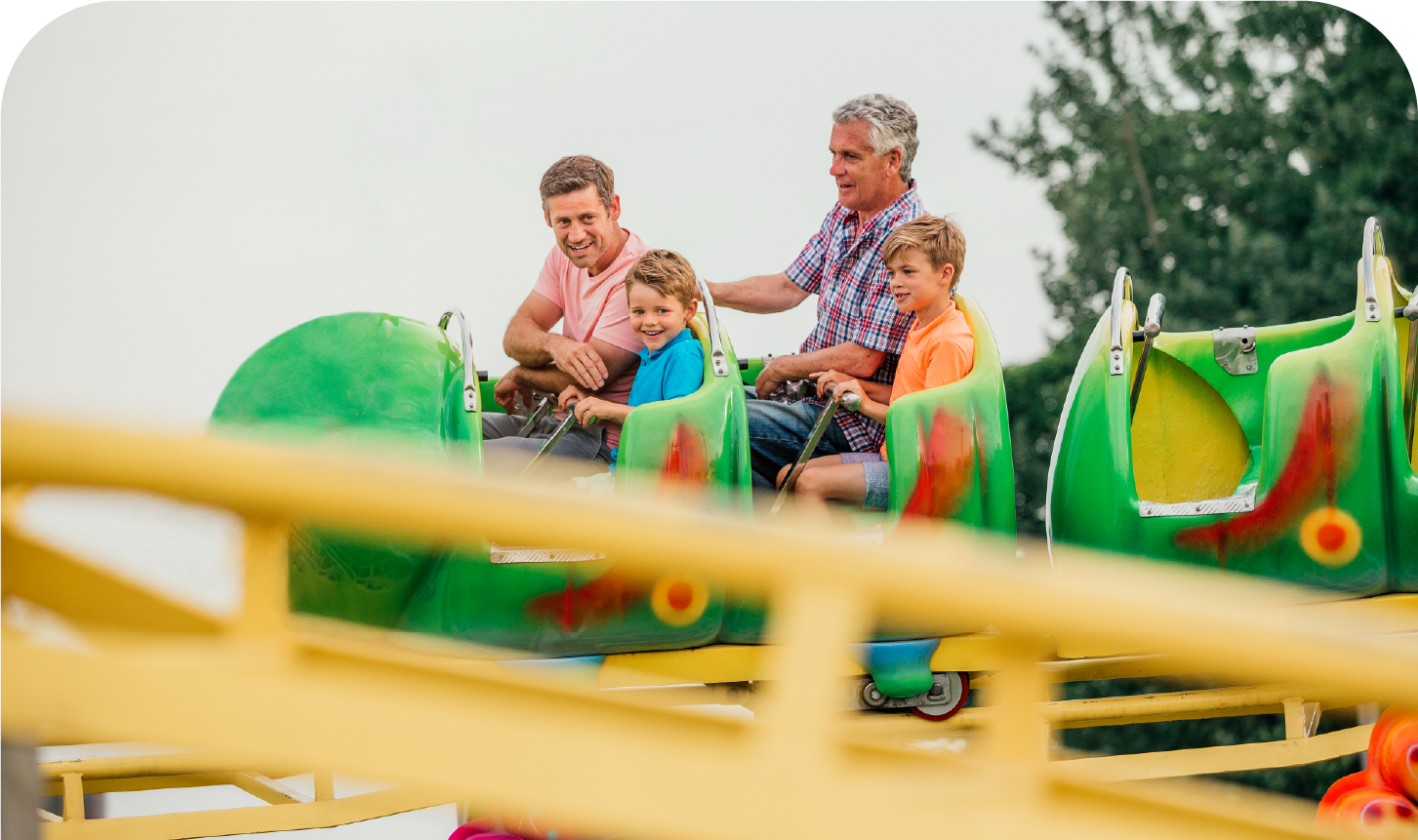 A family is riding a roller coaster at an amusement park.