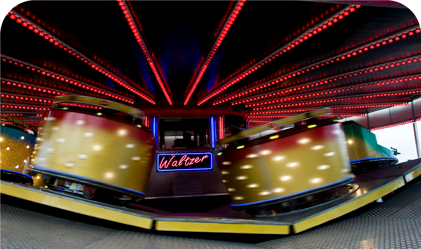 A roller coaster with a neon sign that says wallows