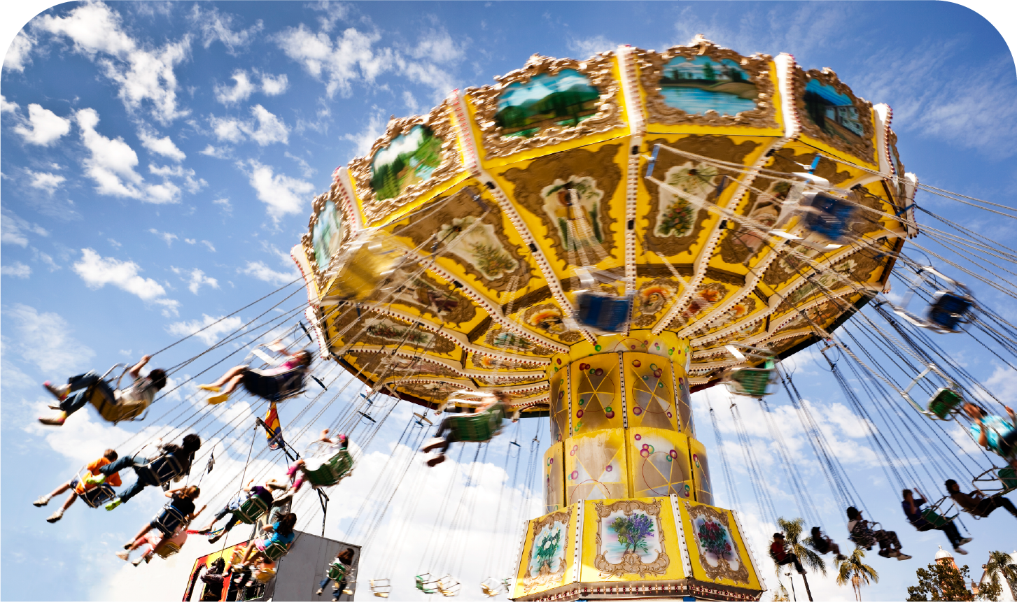 A group of people are riding a merry go round at an amusement park.