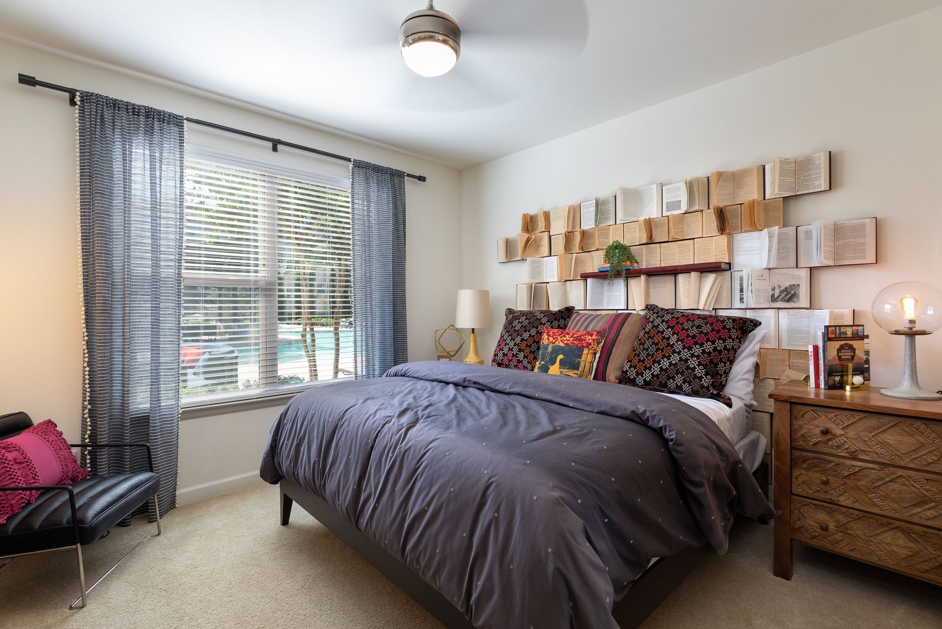 A bedroom with a large bed and a ceiling fan