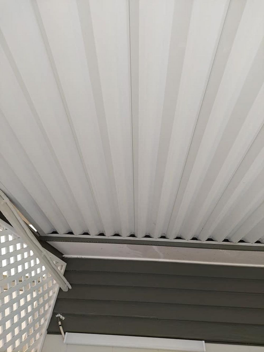 White Corrugated Ceiling With a Gray Trim, Attached to a Building — DAH Cleaning Services In Bungalow, QLD