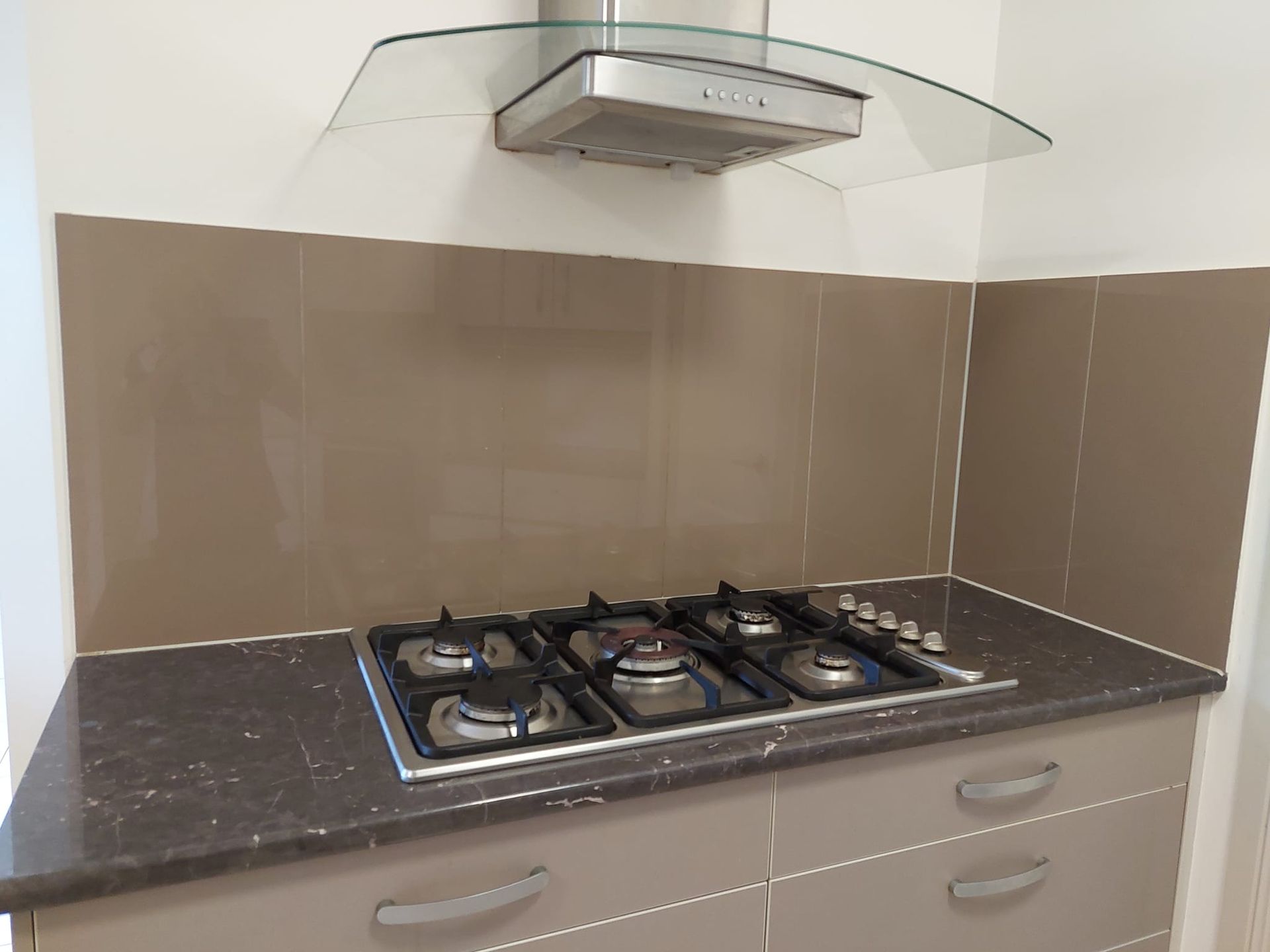 A Kitchen With A Stove Top Oven And A Hood — DAH Cleaning Service In Edge Hill, QLD