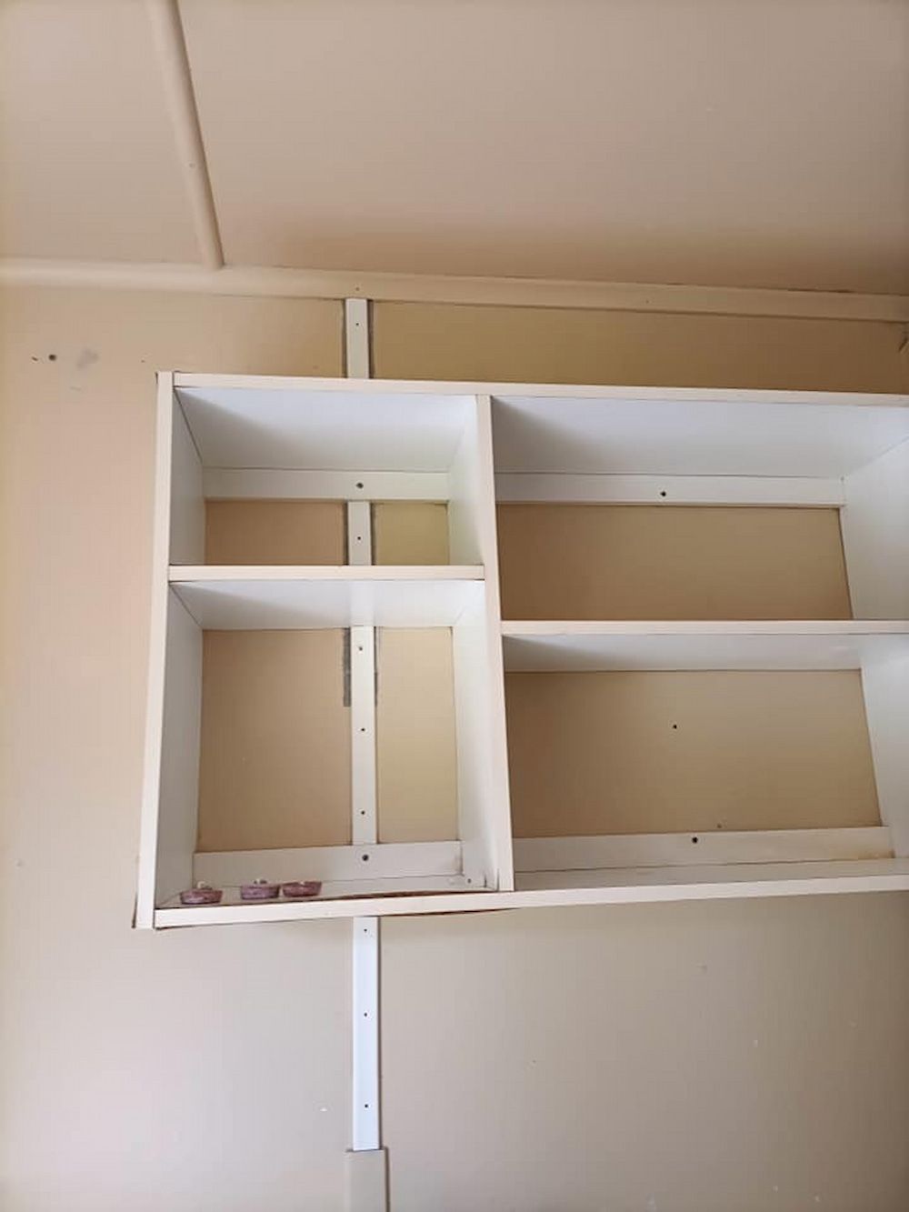White Built-in Shelves Attached to a Tan Wall — DAH Cleaning Services In Bungalow, QLD