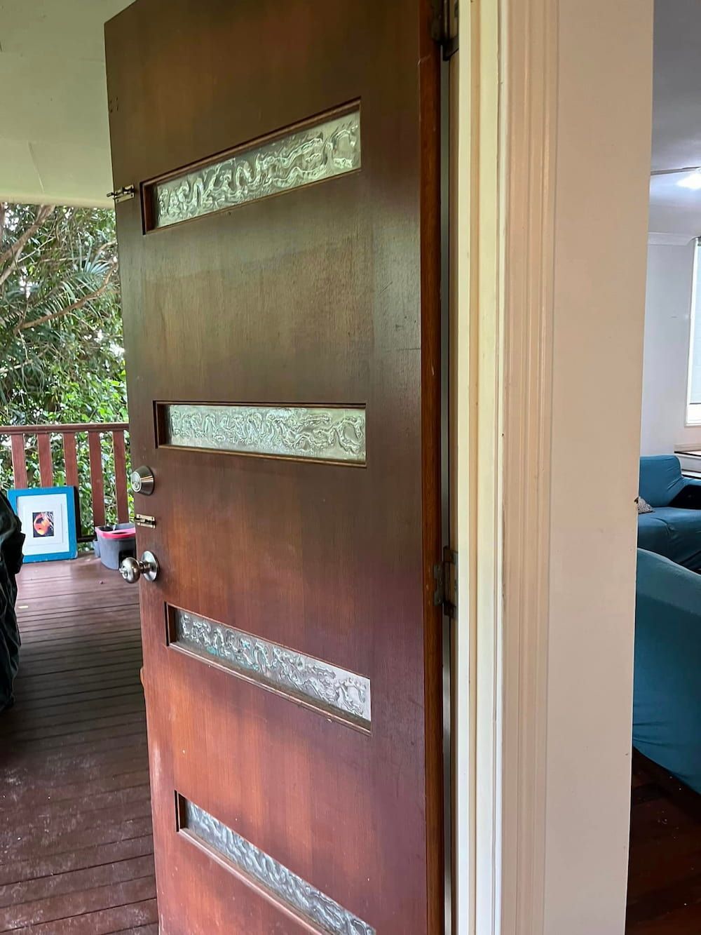 A Brown Front Door With Frosted Glass Panels is Slightly Ajar — DAH Cleaning Services In Atherton, QLD