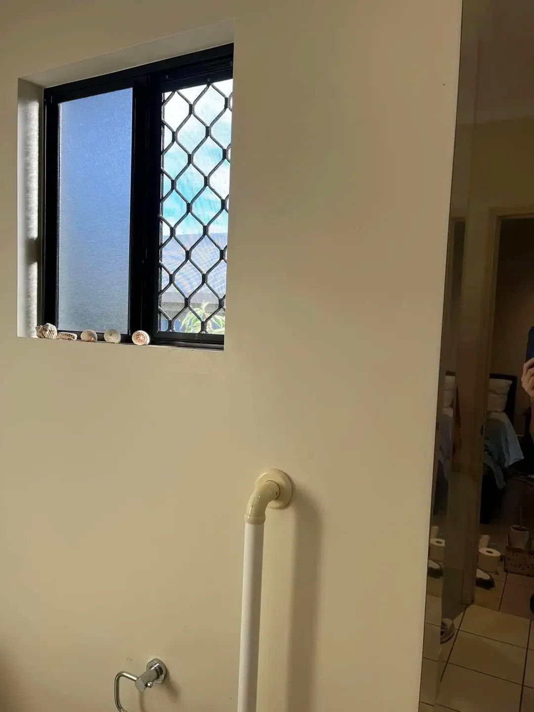 A Small Square Window With Security Bars — DAH Cleaning Services In Bungalow, QLD