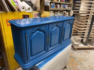 Blue painted cabinet in a workshop.