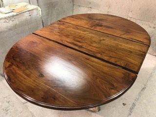 Oval wooden table with a glossy finish.