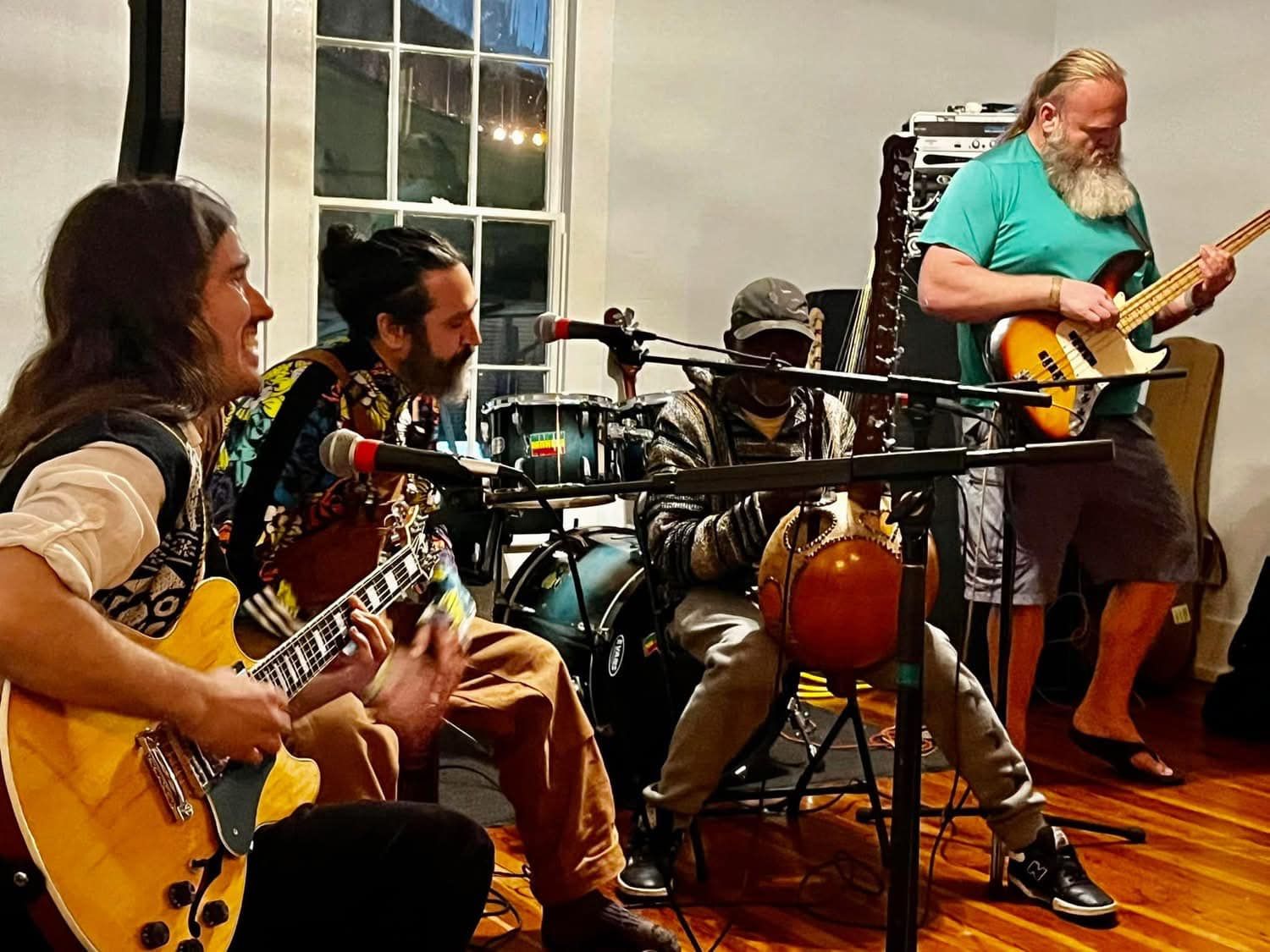 A band playing an intimate live set inside the historic Depot Village house in Gainesville
