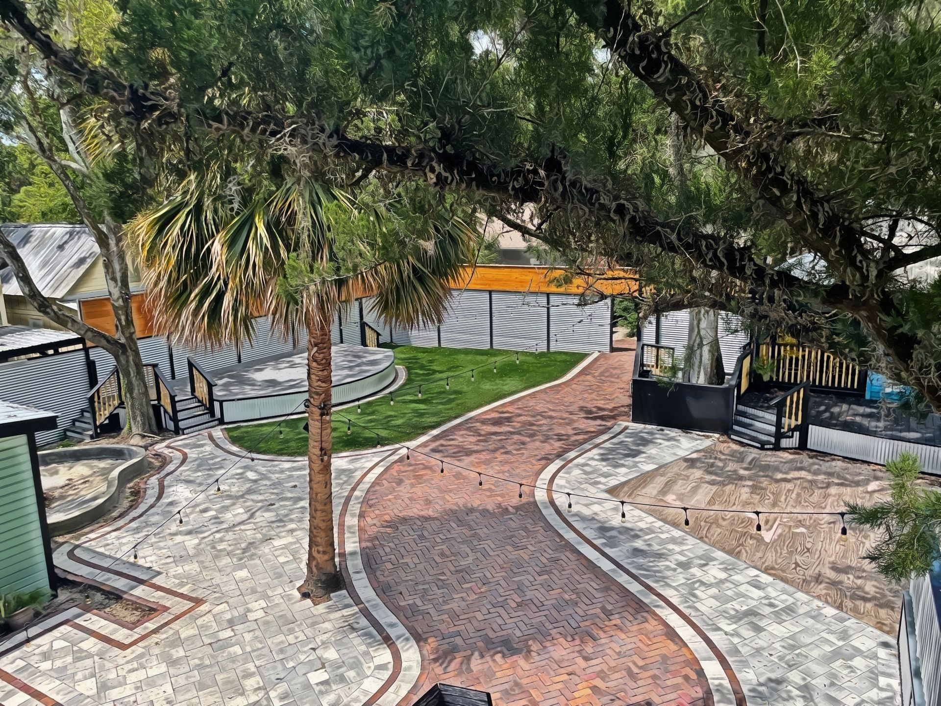 Aerial view of the Depot Village courtyard, stage, and grounds near Depot Park in downtown Gainesville