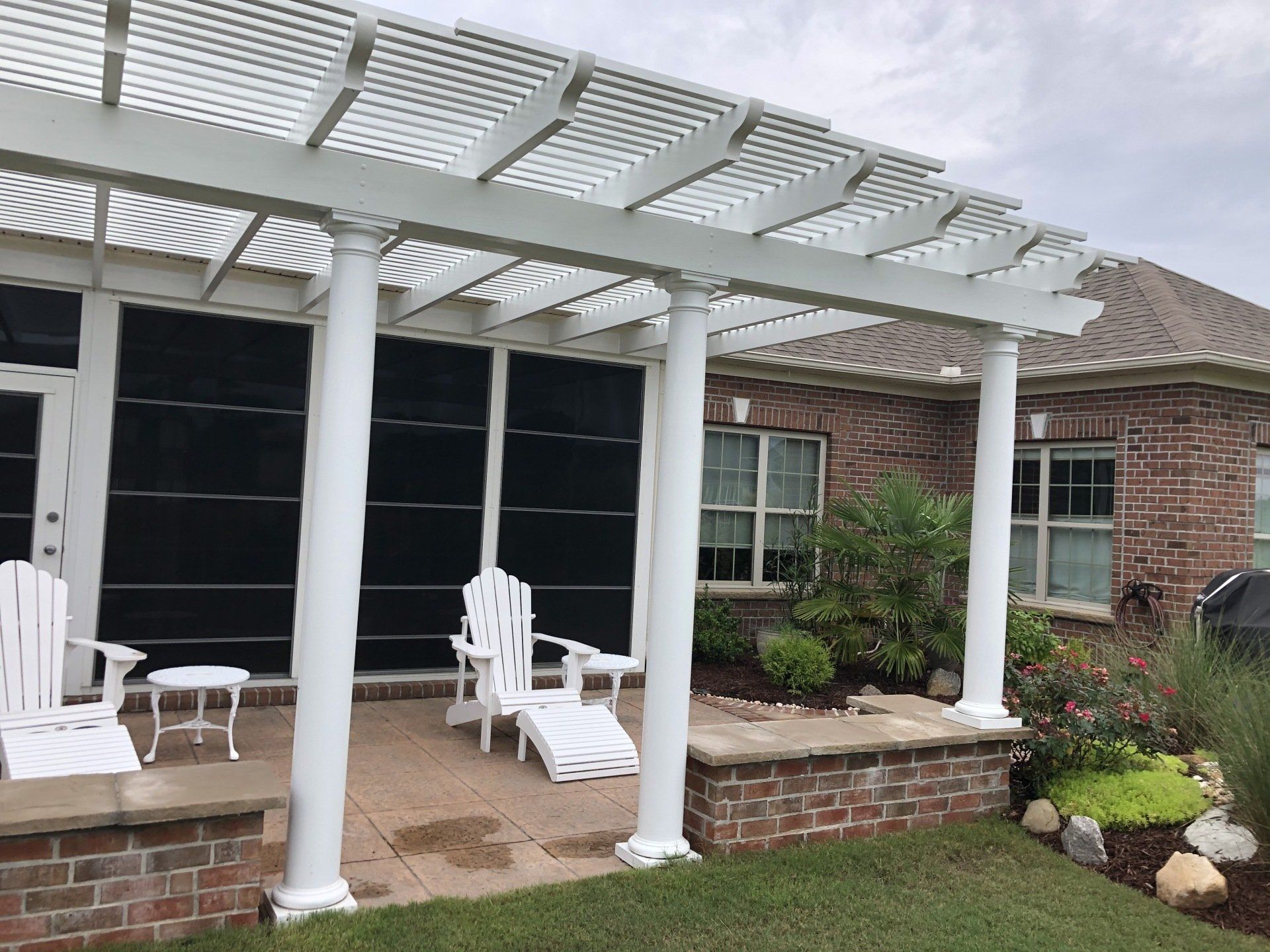 New pergola with white pillars and a outdoor patio