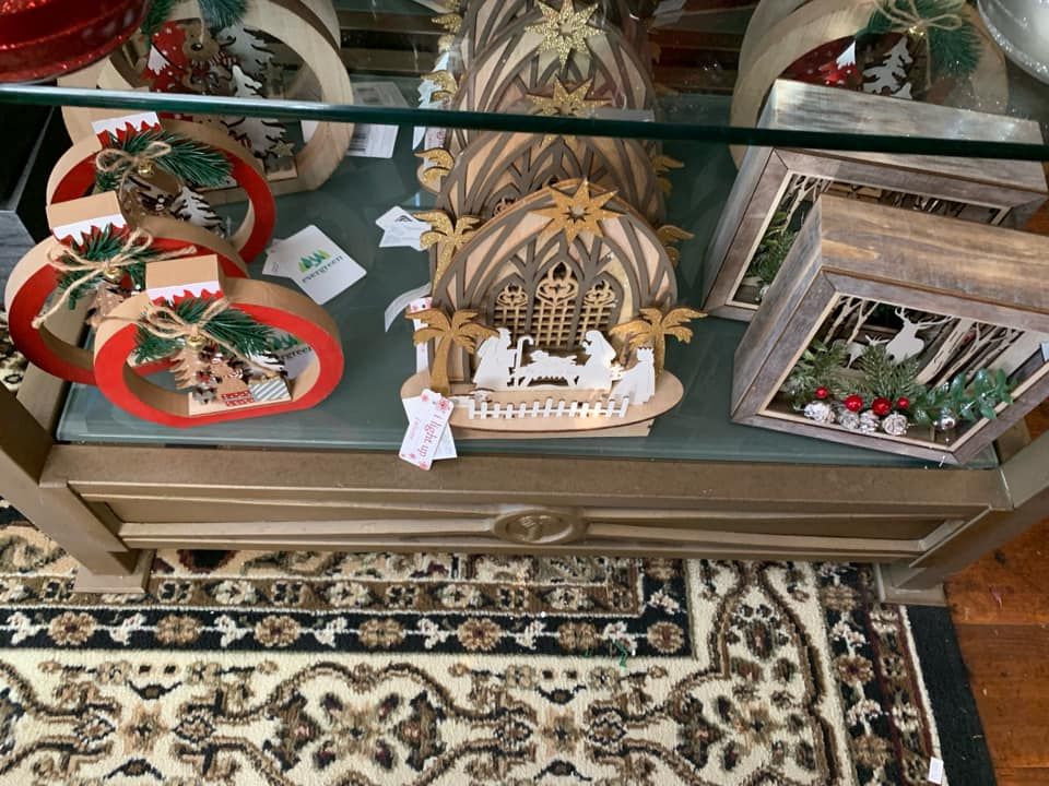 A display case filled with christmas decorations and a nativity scene.
