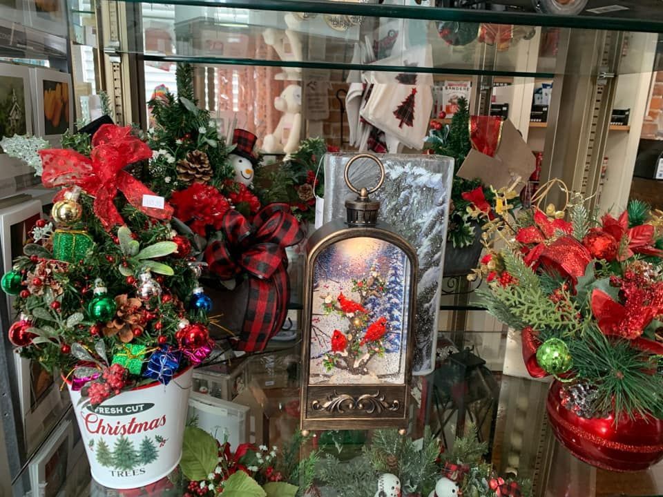 A display case filled with christmas decorations and a lantern.