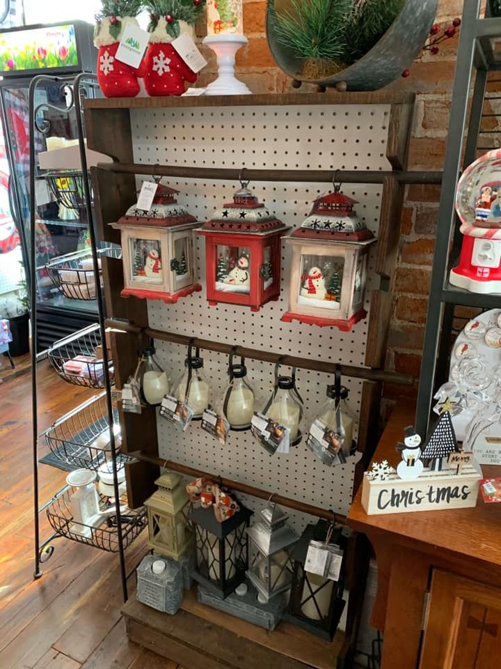 A display of christmas lanterns on a shelf in a store.