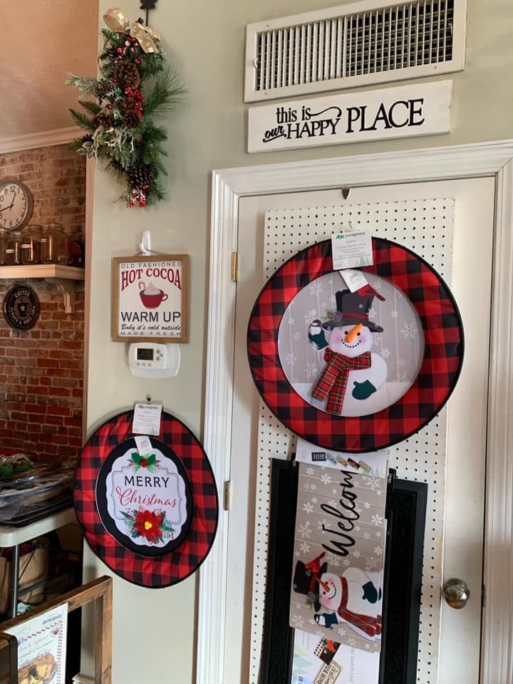 A christmas wreath with a snowman on it is hanging on a door.